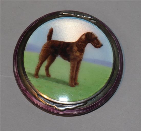A 1930s silver-gilt and guilloche enamel circular compact, the hinged cover decorated with an Airedale Terrier,